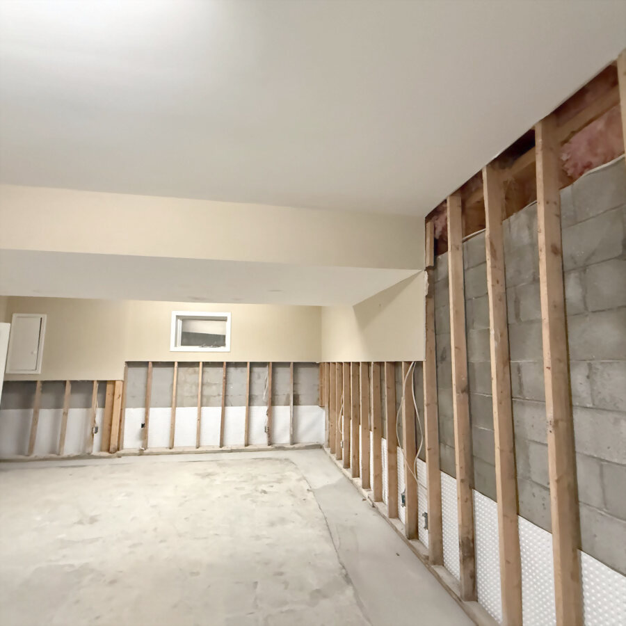 A lower room stripped back to the studs after the drywall came out.
