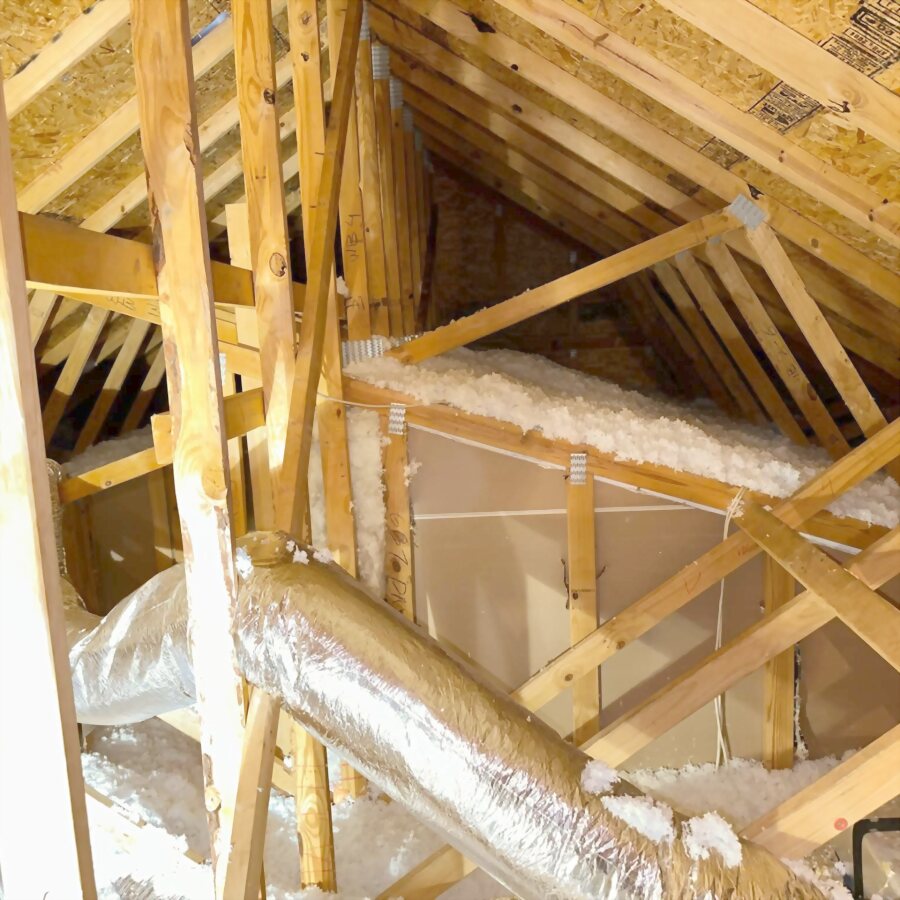 An attic after the work, duct runs clear and insulation laid back in.